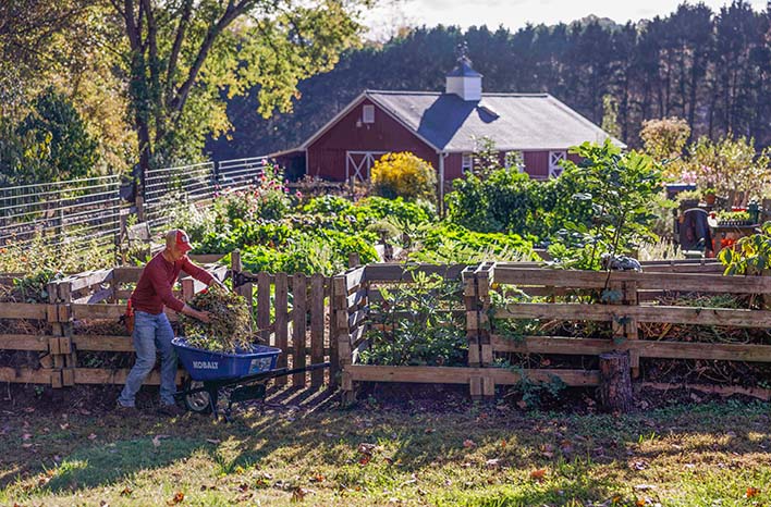 Joe's compost bins with barn in the distance.